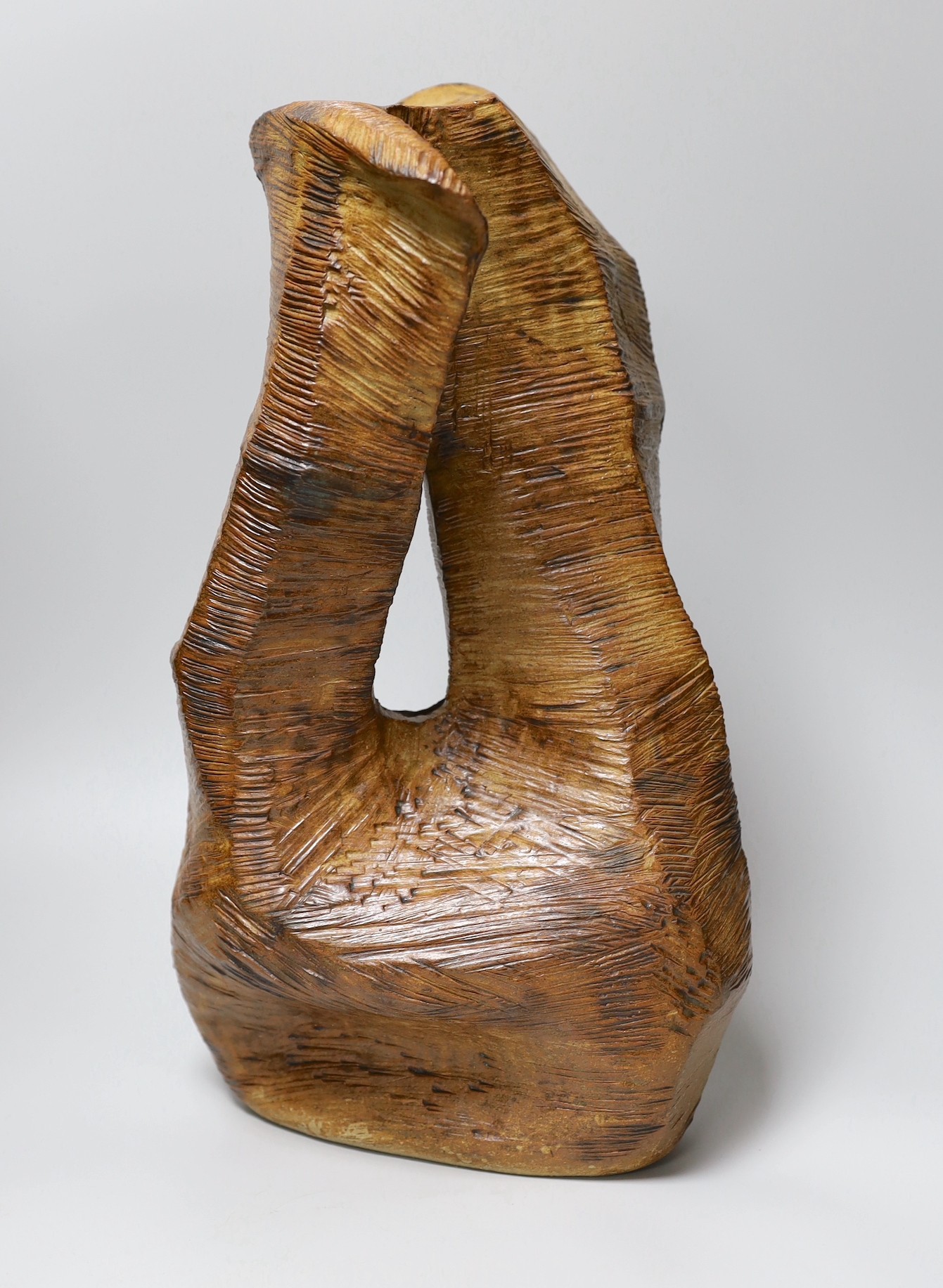 Ruth Sulke - a large brown copper glazed stoneware angular “wooden” sculpture with central hole, 1985, 42cm, See Sulke, Ruth - Ceramic Sculpture by Ruth Sulke, Hanart 2 Gallery, 1987, page 30
